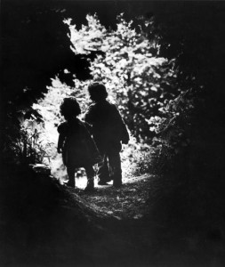 Children of photographer W. Eugene Smith walking hand-in-hand in woods behind his home, in photo entitled "The Walk to Paradise Garden"